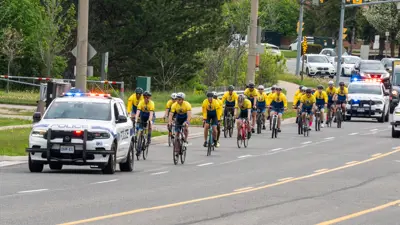 Police escorting cyclists on road