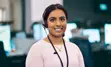 Smiling employee facing camera while wearing headset