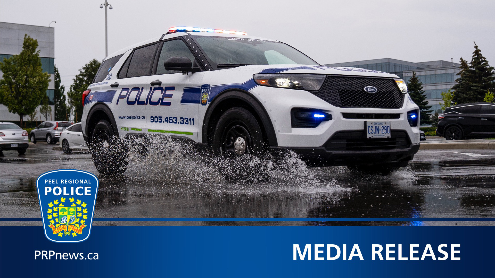 Peel police cruiser splashing through puddle